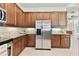Gourmet kitchen featuring stainless steel appliances, granite countertops, and custom cabinetry at 9008 Brookfield Ter, Bradenton, FL 34212