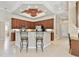 Open kitchen with tile floors, granite countertops, stainless steel appliances, and breakfast bar with seating at 9008 Brookfield Ter, Bradenton, FL 34212