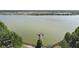 Picturesque lake view featuring a charming pier and lush green trees at 9008 Brookfield Ter, Bradenton, FL 34212