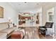 Open-concept living room with wood floors, a ceiling fan, and seamless flow to the kitchen at 9008 Brookfield Ter, Bradenton, FL 34212