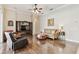 Inviting living room featuring wood floors, a ceiling fan, and a cozy seating area at 9008 Brookfield Ter, Bradenton, FL 34212