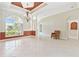 Elegant living room with tiled floors, decorative lighting, and a large window overlooking the front yard at 9008 Brookfield Ter, Bradenton, FL 34212
