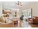 Comfortable living room featuring hardwood floors, ceiling fan, and sliding glass doors to the outdoor patio at 9008 Brookfield Ter, Bradenton, FL 34212
