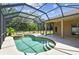 Backyard pool and patio area surrounded by lush landscaping and a screened enclosure for privacy at 9008 Brookfield Ter, Bradenton, FL 34212