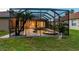 Enjoy the private screened pool with a spa, surrounded by lush landscaping and space for outdoor relaxation at 9008 Brookfield Ter, Bradenton, FL 34212