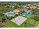 Aerial view showcasing a pool, shuffleboard court, and sand volleyball court at 9008 Brookfield Ter, Bradenton, FL 34212