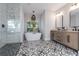 Modern bathroom with stylish flooring, soaking tub, walk in shower, and double vanity at 9017 Province St, Sarasota, FL 34240