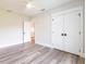 Clean bedroom featuring wood floors, a ceiling fan, and a double door closet at 9017 Province St, Sarasota, FL 34240