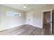 Neutral-toned bedroom featuring wood floors, a ceiling fan, and a closet with double doors at 9017 Province St, Sarasota, FL 34240