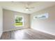 Bright bedroom with light wood floors and windows overlooking a lush, green yard at 9017 Province St, Sarasota, FL 34240