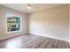Simple bedroom featuring wood floors, a ceiling fan, and a bright window at 9017 Province St, Sarasota, FL 34240