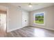 Neutral-toned bedroom featuring wood floors, a ceiling fan, and a closet with double doors at 9017 Province St, Sarasota, FL 34240