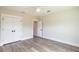 Simple bedroom with ceiling fan and wood floors, looking into an adjoining room at 9017 Province St, Sarasota, FL 34240