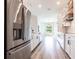 Gourmet kitchen featuring stainless steel appliances, white cabinetry, and an eat-in bar at 9017 Province St, Sarasota, FL 34240