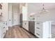 Bright kitchen with stainless steel appliances, white cabinets, and eat-in island at 9017 Province St, Sarasota, FL 34240
