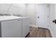 Bright laundry room featuring front load machines and tile flooring at 9017 Province St, Sarasota, FL 34240