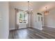 Spacious living room with tile floors, modern lighting and large windows at 9017 Province St, Sarasota, FL 34240
