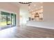 Bright living space with wood-look tile floors, sliding doors, and a view into the modern kitchen at 9017 Province St, Sarasota, FL 34240