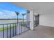 Balcony featuring waterfront views and black metal railings, providing a serene and relaxing outdoor space at 9393 Midnight Pass Rd # 603, Sarasota, FL 34242