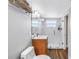 Bathroom features wood-look floors, walk-in shower with white tile surround, and a vanity at 9393 Midnight Pass Rd # 603, Sarasota, FL 34242