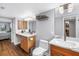 Bright bathroom featuring wood-look floors, double vanity with a view to the bedroom at 9393 Midnight Pass Rd # 603, Sarasota, FL 34242