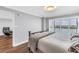 Bedroom featuring wood-look floors, sliding glass doors to a balcony, and simple decor at 9393 Midnight Pass Rd # 603, Sarasota, FL 34242