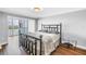 Bedroom features wood-look flooring, sliding glass doors to a patio, and simple decor at 9393 Midnight Pass Rd # 603, Sarasota, FL 34242