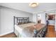 A spacious bedroom features a walk-in closet, a bed with metal frame and wood-look flooring at 9393 Midnight Pass Rd # 603, Sarasota, FL 34242