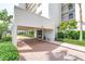 Building entrance featuring covered parking and well-maintained landscaping at 9393 Midnight Pass Rd # 603, Sarasota, FL 34242