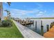 A private boat dock featuring a boat slip with boat, waterway access and lush landscaping, perfect for waterfront living at 9393 Midnight Pass Rd # 603, Sarasota, FL 34242