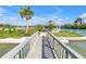 Picturesque walkway leading to an island gazebo, surrounded by lush landscaping and scenic water views in the community at 9393 Midnight Pass Rd # 603, Sarasota, FL 34242