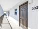 Hallway entrance featuring a secure front door with digital keypad entry, and an exterior window offering natural light at 9393 Midnight Pass Rd # 603, Sarasota, FL 34242