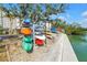 Community kayak storage rack by the water with multiple colorful kayaks at 9393 Midnight Pass Rd # 603, Sarasota, FL 34242