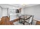 Modern kitchen area with white counters, stainless steel appliances and wood floors at 9393 Midnight Pass Rd # 603, Sarasota, FL 34242