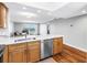 Kitchen featuring stainless appliances, quartz counters, and an open view to living area at 9393 Midnight Pass Rd # 603, Sarasota, FL 34242