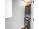 A convenient, gray stackable washer and dryer are in a small laundry room at 9393 Midnight Pass Rd # 603, Sarasota, FL 34242
