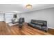 Open-concept living space with wood floors, contemporary furniture, and natural light at 9393 Midnight Pass Rd # 603, Sarasota, FL 34242