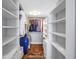 Walk-in closet with plenty of shelving space and dark wood-look floors at 9393 Midnight Pass Rd # 603, Sarasota, FL 34242