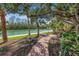 Beautiful brick walkway leads to the waterfront, lined with mature trees and landscaping, and a tranquil sitting area at 9393 Midnight Pass Rd # 603, Sarasota, FL 34242