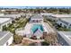 Aerial view showcasing a community pool surrounded by well-maintained homes and lush landscaping at 9822 Desoto Ct, Bradenton, FL 34210