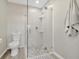 Bright bathroom featuring a glass shower door, hexagon tile flooring, and sleek fixtures at 9822 Desoto Ct, Bradenton, FL 34210