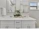 Bathroom featuring a double sink vanity, neutral decor, and modern fixtures at 9822 Desoto Ct, Bradenton, FL 34210