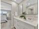 Bright bathroom featuring a double vanity with modern fixtures and a glimpse into the bedroom at 9822 Desoto Ct, Bradenton, FL 34210