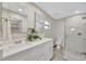 Bathroom featuring double vanity, luxurious finishes, and a glass shower at 9822 Desoto Ct, Bradenton, FL 34210