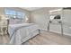 Bedroom showcasing great natural light, neutral color palette, and wood-look flooring at 9822 Desoto Ct, Bradenton, FL 34210