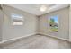 Bedroom featuring light gray paint, two windows, and modern ceiling fan at 9822 Desoto Ct, Bradenton, FL 34210