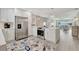 Modern, open-concept kitchen with stainless steel appliances, quartz countertops, and stylish pendant lighting at 9822 Desoto Ct, Bradenton, FL 34210