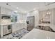 Bright kitchen featuring white cabinets, stainless steel appliances, and patterned flooring at 9822 Desoto Ct, Bradenton, FL 34210