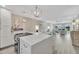 Bright, open kitchen featuring a large island, stainless steel appliances, and seamless flow to the living area at 9822 Desoto Ct, Bradenton, FL 34210