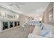 Bright living room that opens to the kitchen with bar seating and coastal accents at 9822 Desoto Ct, Bradenton, FL 34210
